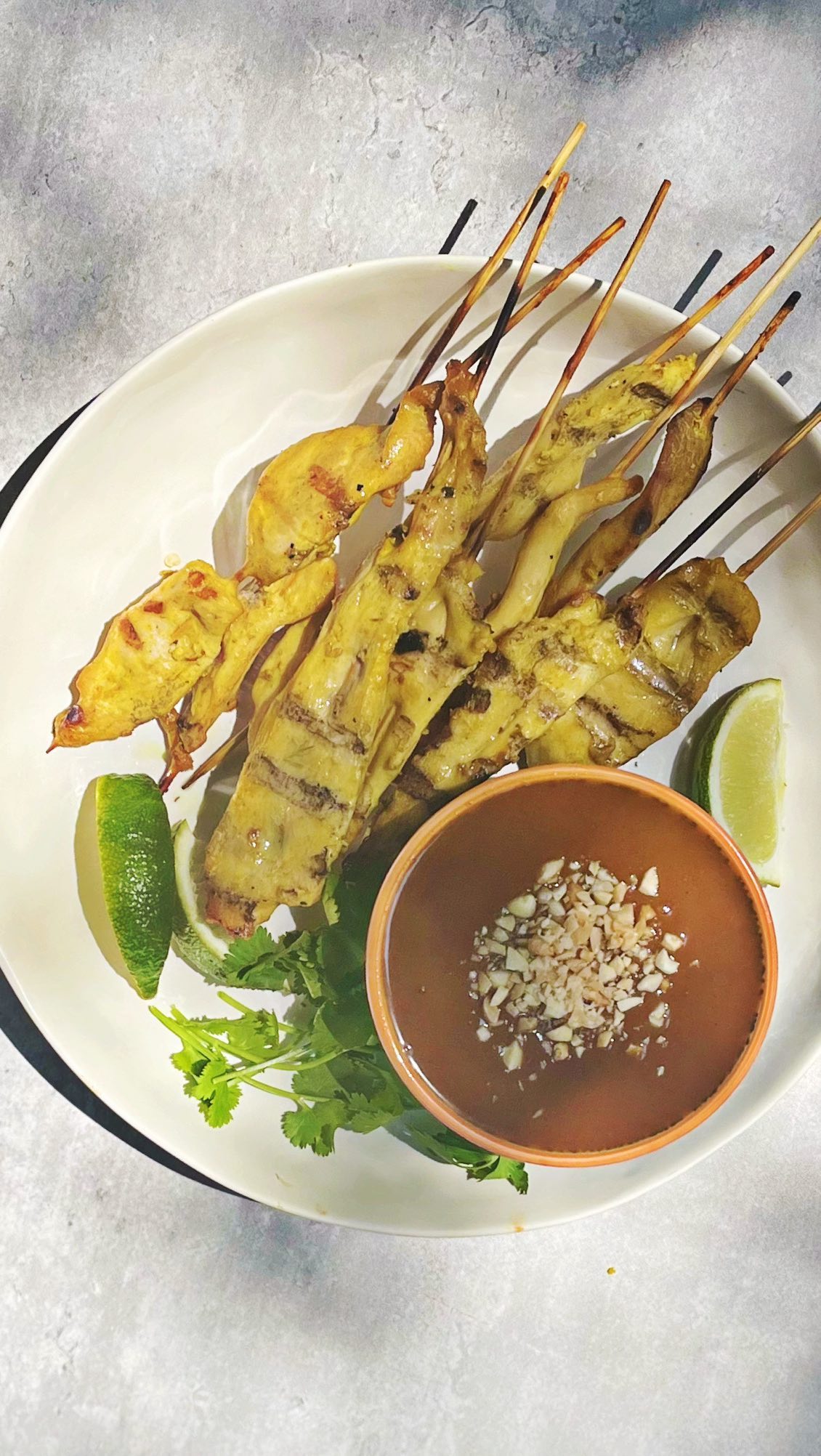Follow @dinnerreinvented for recipes like - Chicken satay with homemade peanut dipping sauce, which is the easiest dish to grill and serve poolside this summer. It’s light and healthy and the perfect finger food! Full recipe link in bio! #chickensatay #grilledchicken #grillingseason #grillingrecipes #memorialdayfood #entertaining #summerentertaining #summercooking #peanutsauce #thaifood #easygrilling #summerfood #roniproter #dinnerreinvented