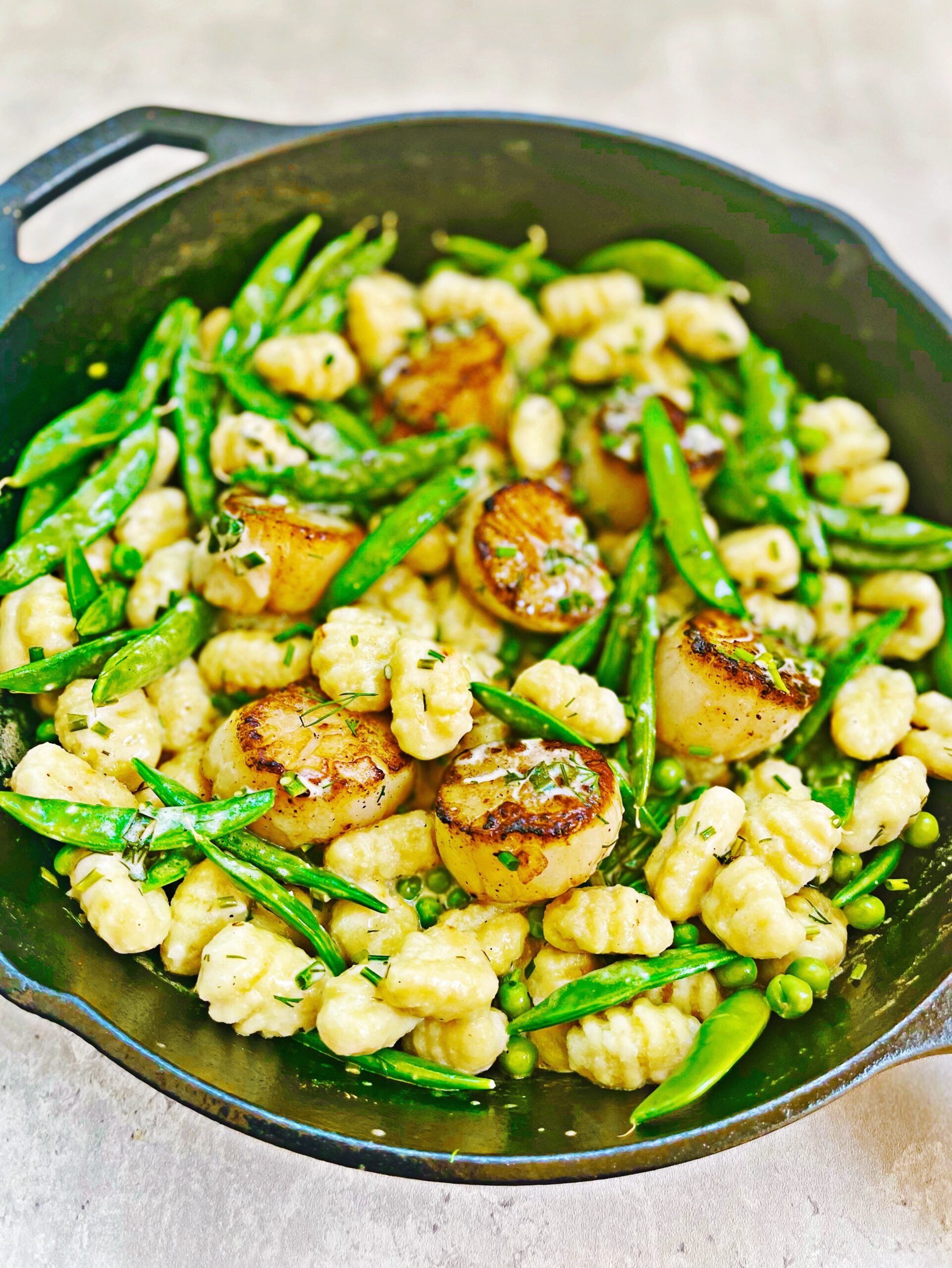 one pot springtime gnocchi with scallops and vegetables